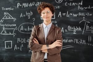 photo of woman standing in front of blackboard