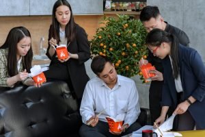 people eating while looking at the documents